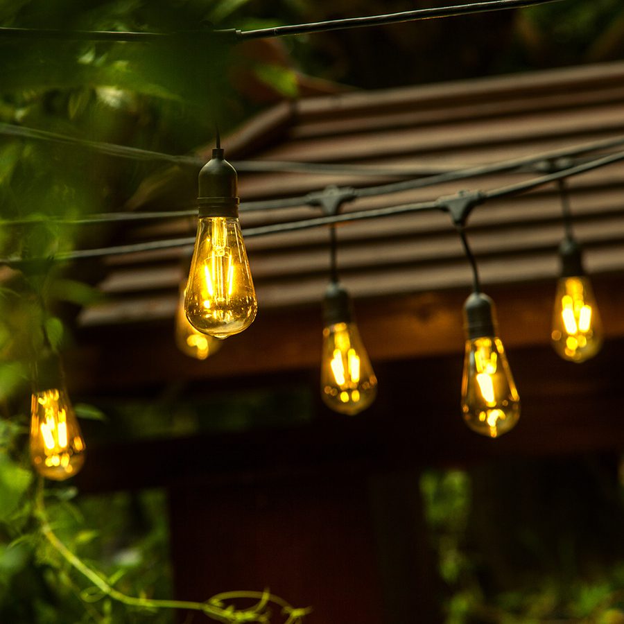 Lowe's outdoor string lights with vintage bulbs on custom home