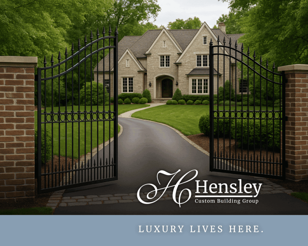 Private gated entrance to a custom luxury home in Indian Hill, Ohio, with a curved driveway, manicured lawn, and surrounding mature trees.